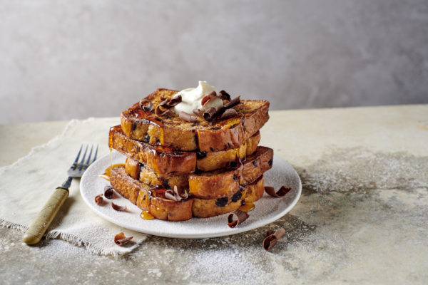 Chocolate Chip brioche French toast, drizzled with maple syrup, whipped cream and chocolate flakes