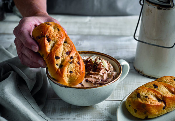 Chocolate Chip Brioche Roll Dipped in a Hot Chocolate with Whipped Cream